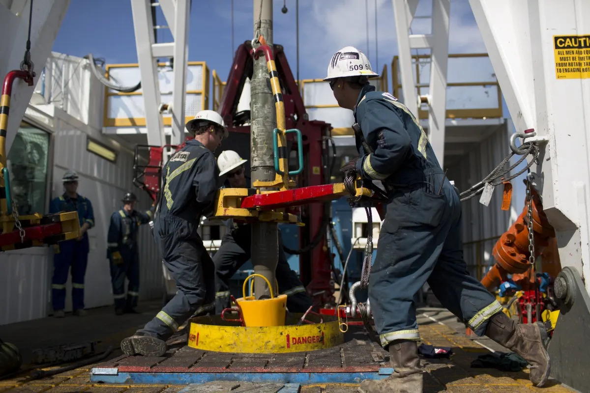 Employees adjust a wedge well at a Cenovus oil production facility in Conklin, Alberta.