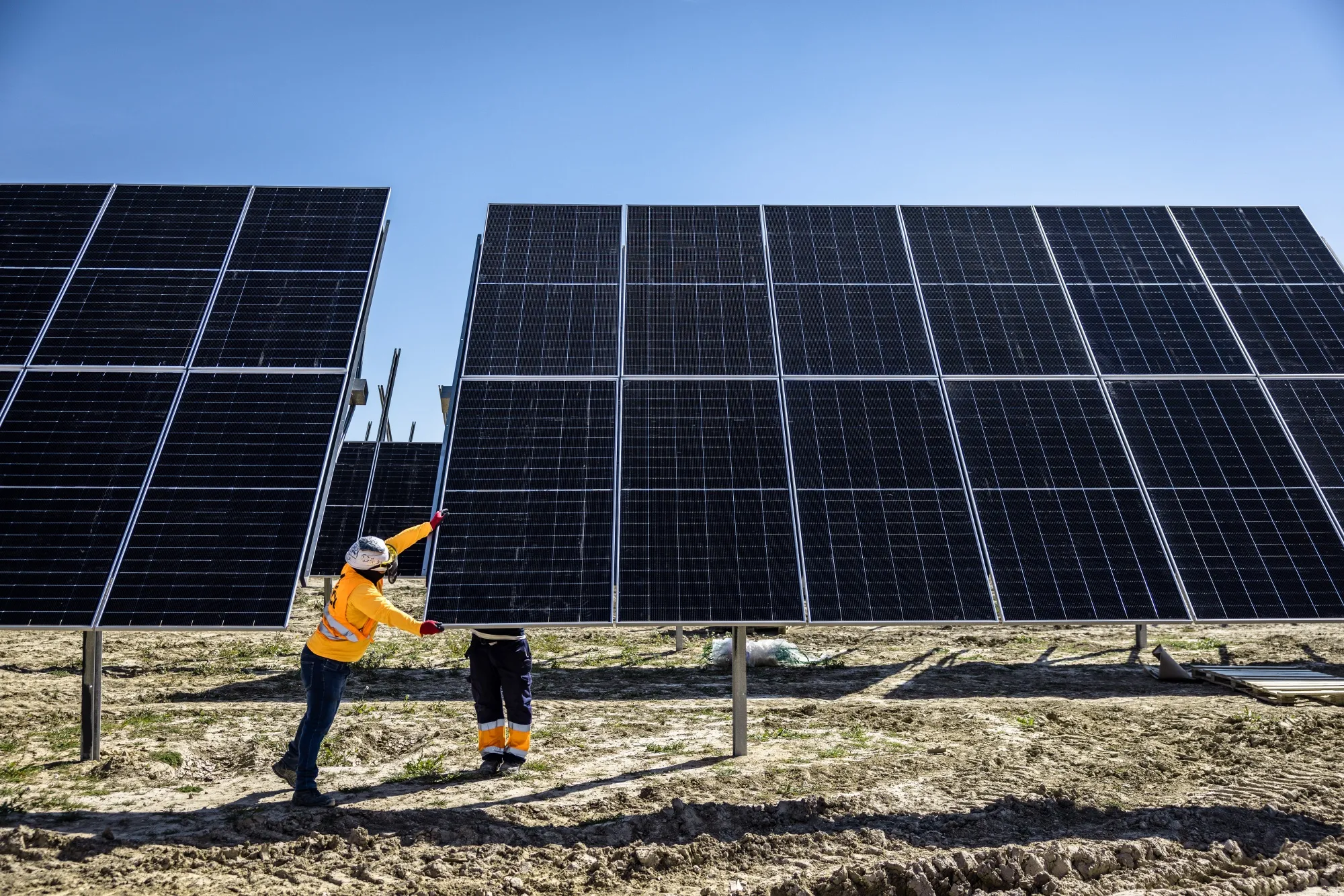 Workers install solar panels near Zaragoza, Spain.