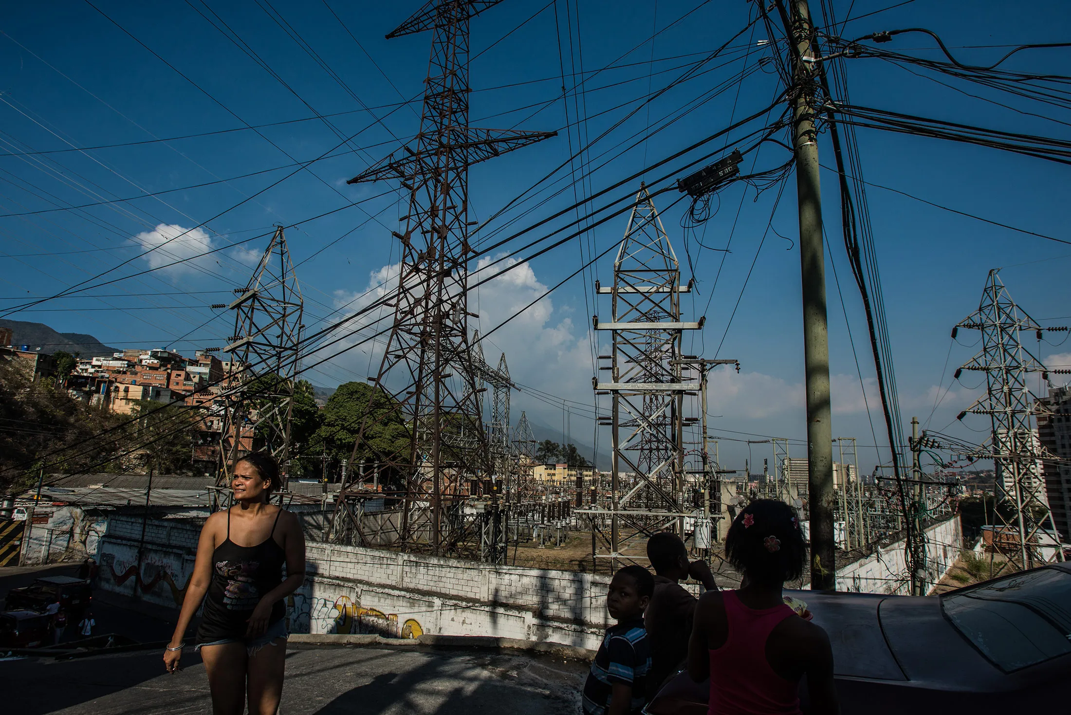 People walk past an electrical substation in Caracas, Venezuela.
