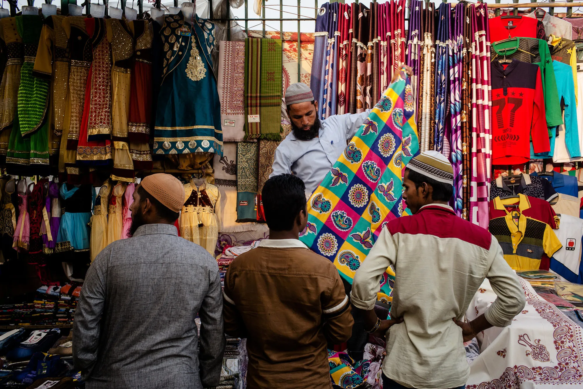 A vendor displays cloth for customers at a stall outside the Jama Masjid during the Muslim holy month of Ramadan in the Old Delhi area of New Delhi, on May 29, 2017.
