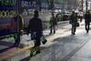 Pedestrians are reflected in an electronic stock board outside a securities firm in Tokyo, Japan, on Thursday, Jan. 7, 2016. Japanese stocks fell for a fourth day, extending a global slide that's seen shares post their worst start to a year since 2000, after China again cut the reference rate for the yuan and trading in the world's second-biggest equity market was halted.