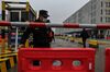 A guard controls the access to the Baishazhou market as members of the WHO team, investigating the origins of the Covid-19 coronavirus, arrive to the market in Wuhan, China, on Jan. 31. 