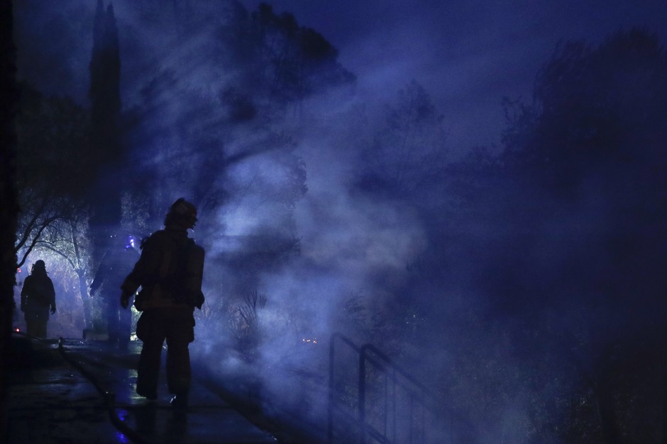 A firefighter surveys a building destroyed by a wildfire near Calistoga, California.