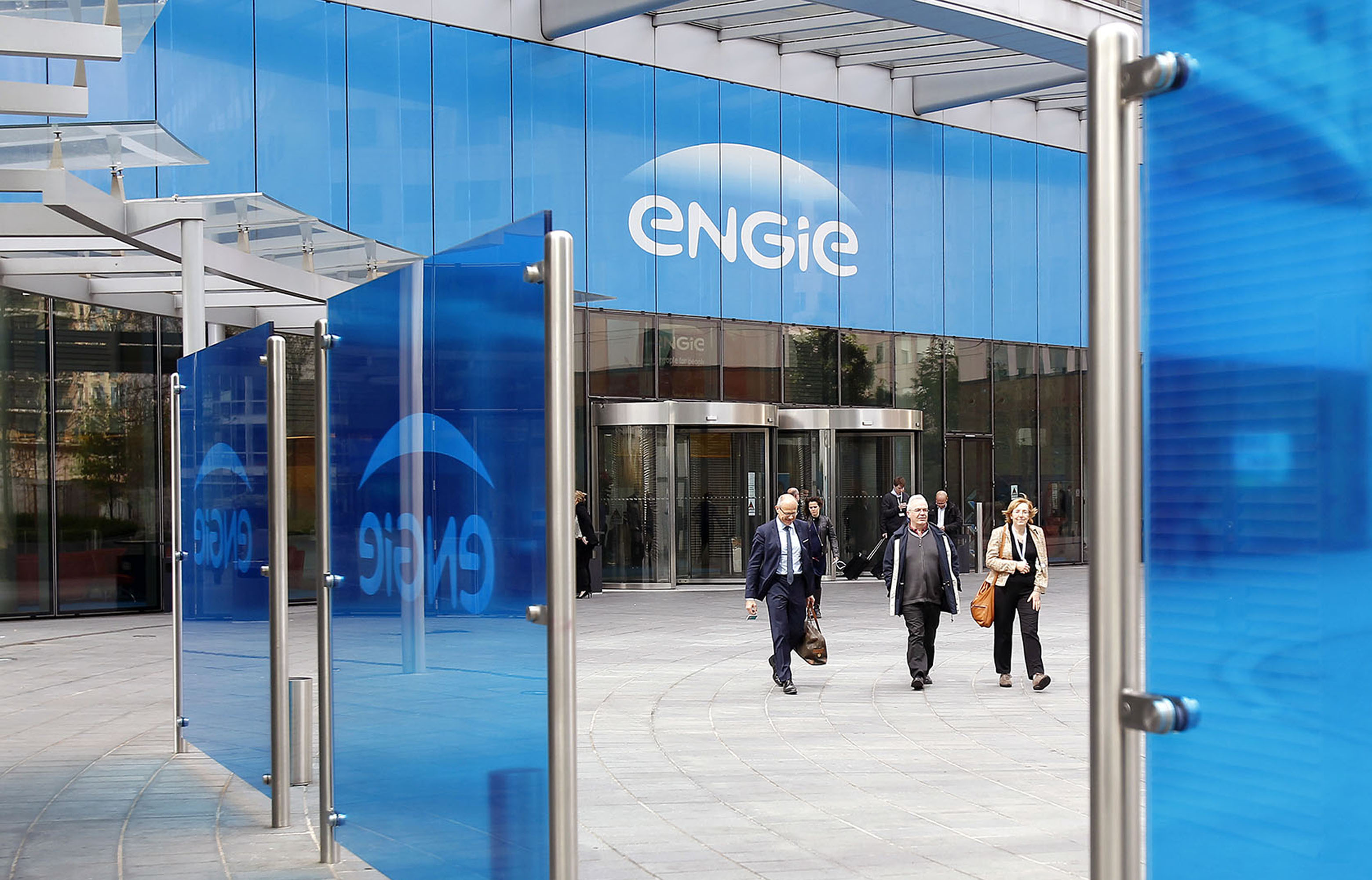 People walk outside of the headquarters of Engie in Paris.