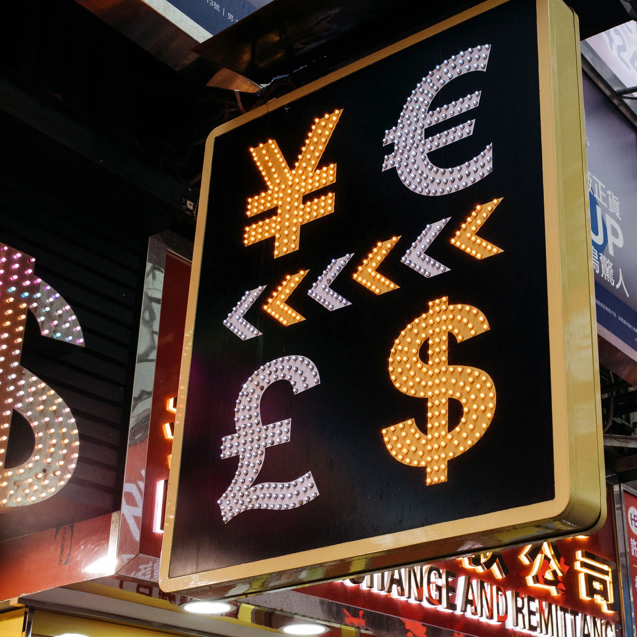 A sign featuring Japanese yen, top left, euro, top right, British pound sterling, bottom left, and U.S. dollar is displayed at a currency exchange store in Hong Kong, China, on Thursday, March 16, 2017. Hong Kong's shopping districts are dotted with money changers advertising their remittance services and conversion rates. There are 1,891 licensed money operators in the city, Hong Kong customs data show.
