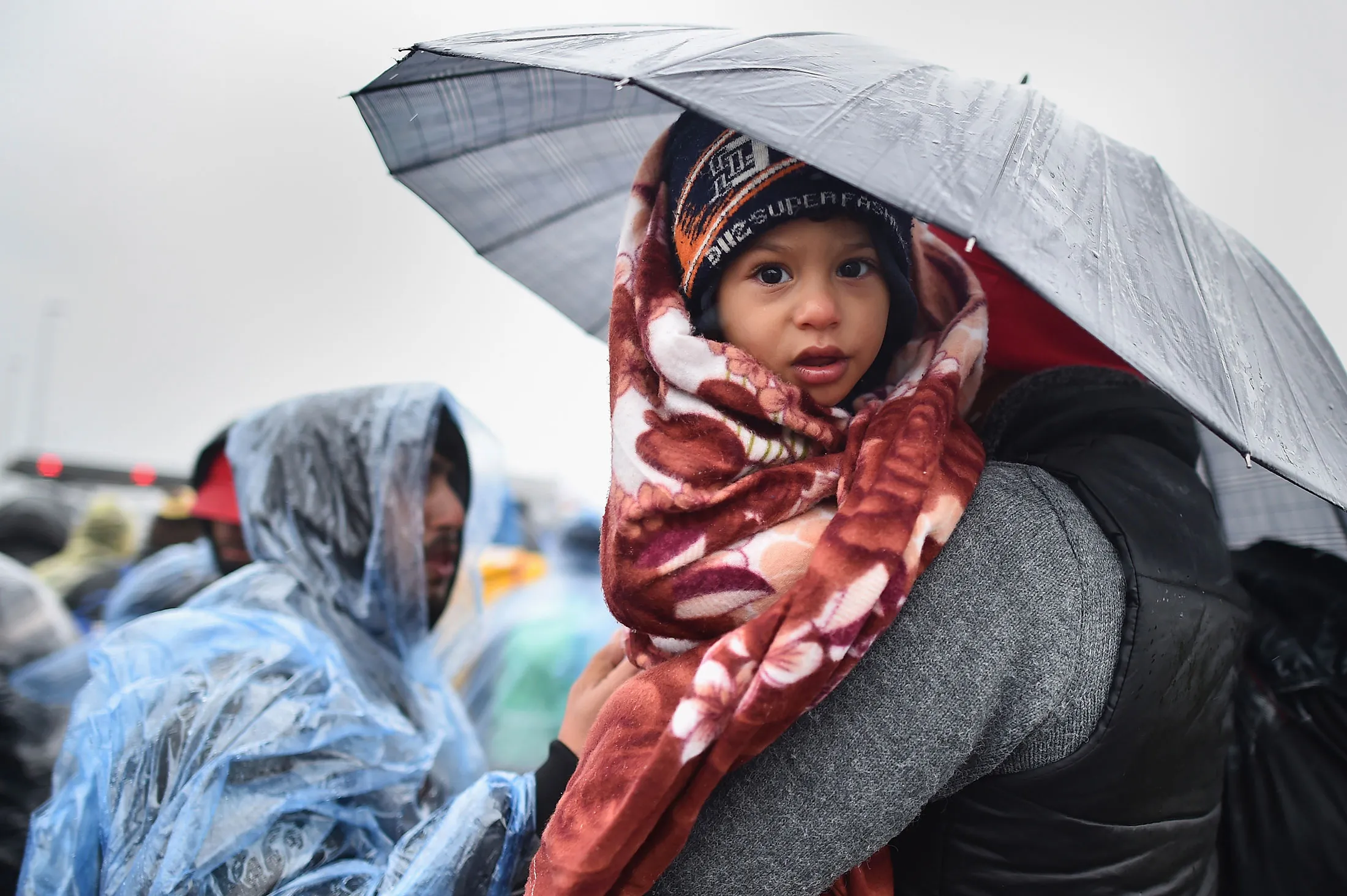 Migrants wait in the rain at the Trnovec crossing on the Croatia-Slovenia border on Oct. 19, 2015.
