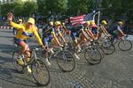 Lance Armstrong parades along the Champs Elysees with his teammates after his sixth victory of the Tour de France in 2004