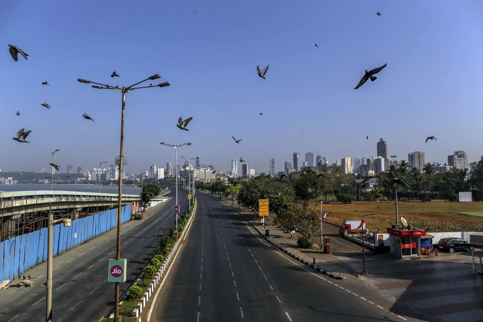 Birds fly over an empty street in Mumbai on April 5.