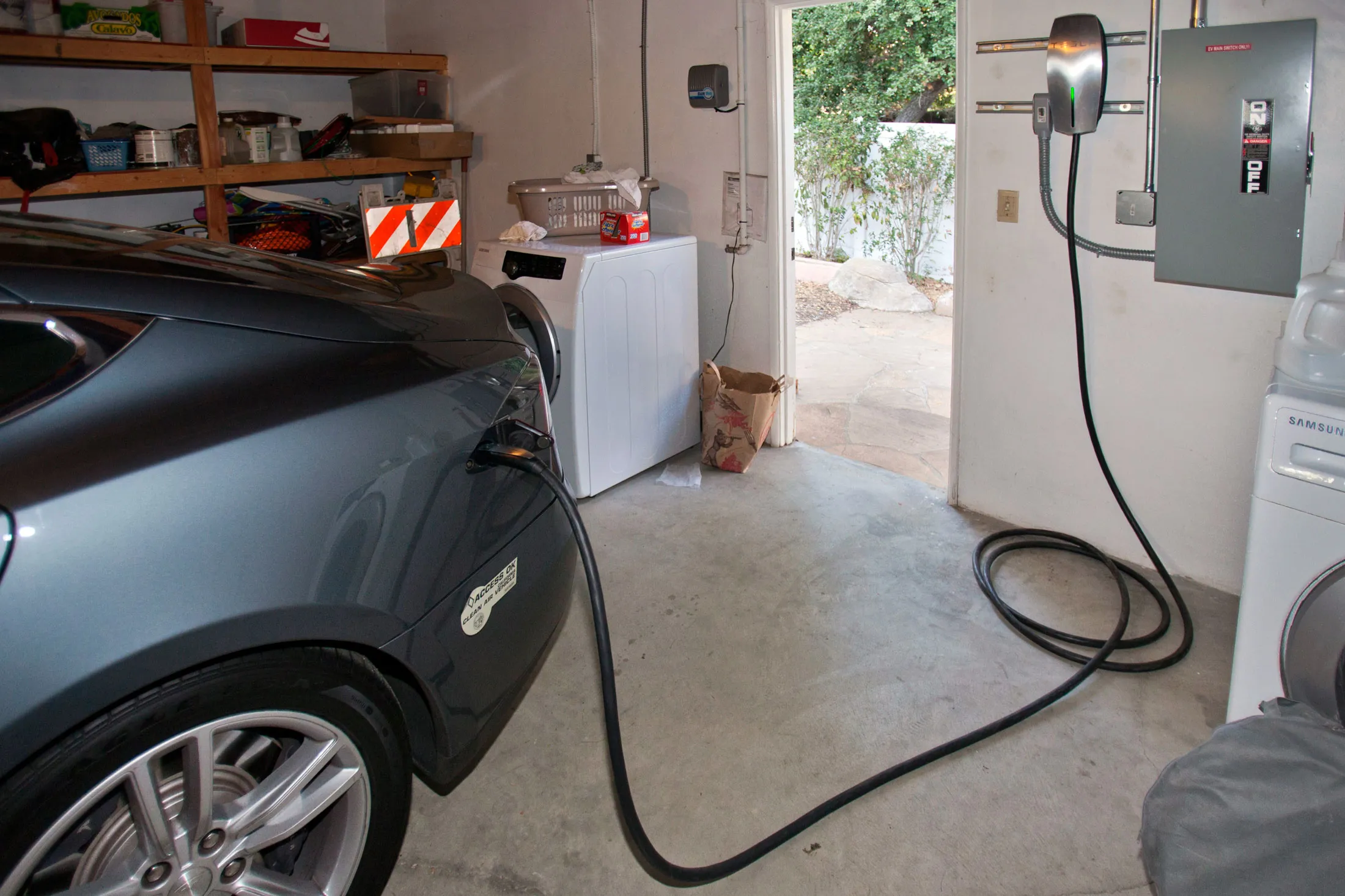 A Tesla electric car recharges in garage powered by solar panels in Los Angeles, California.