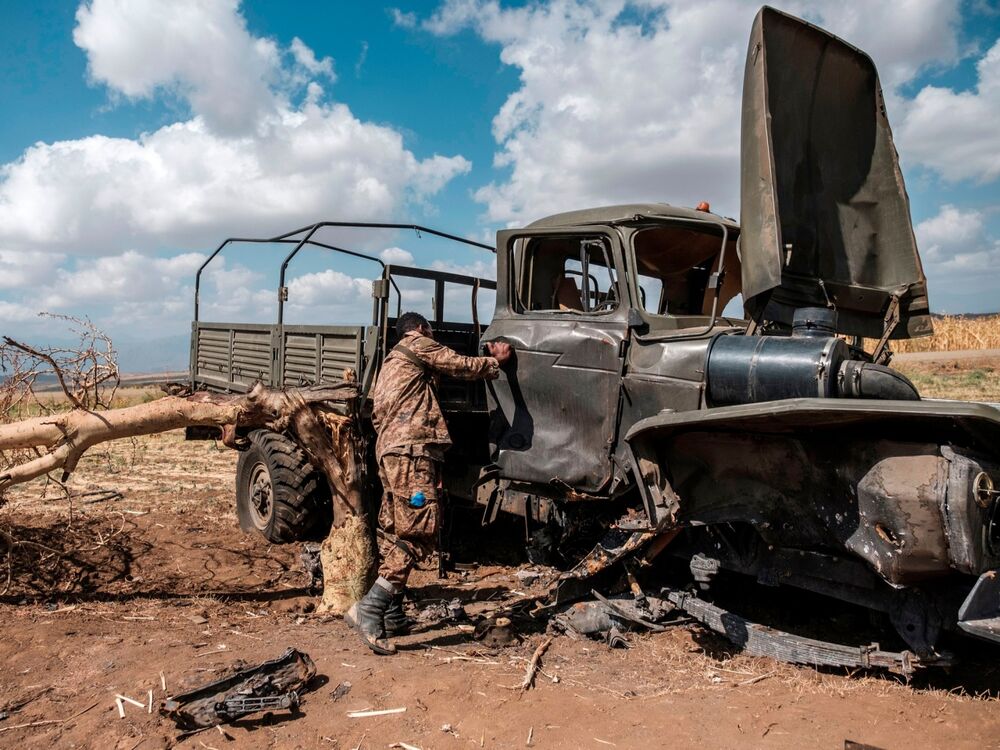 A member of the Ethiopian Defense Forces inspects a damaged military vehicle in Ethiopia’s Tigray region.