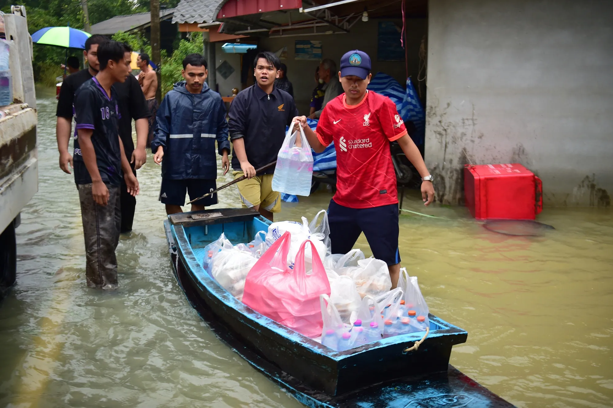 Volunteers distribute food supplies to flood-affected residents&nbsp;in Thailand's southern province of Narathiwat on Nov. 30.