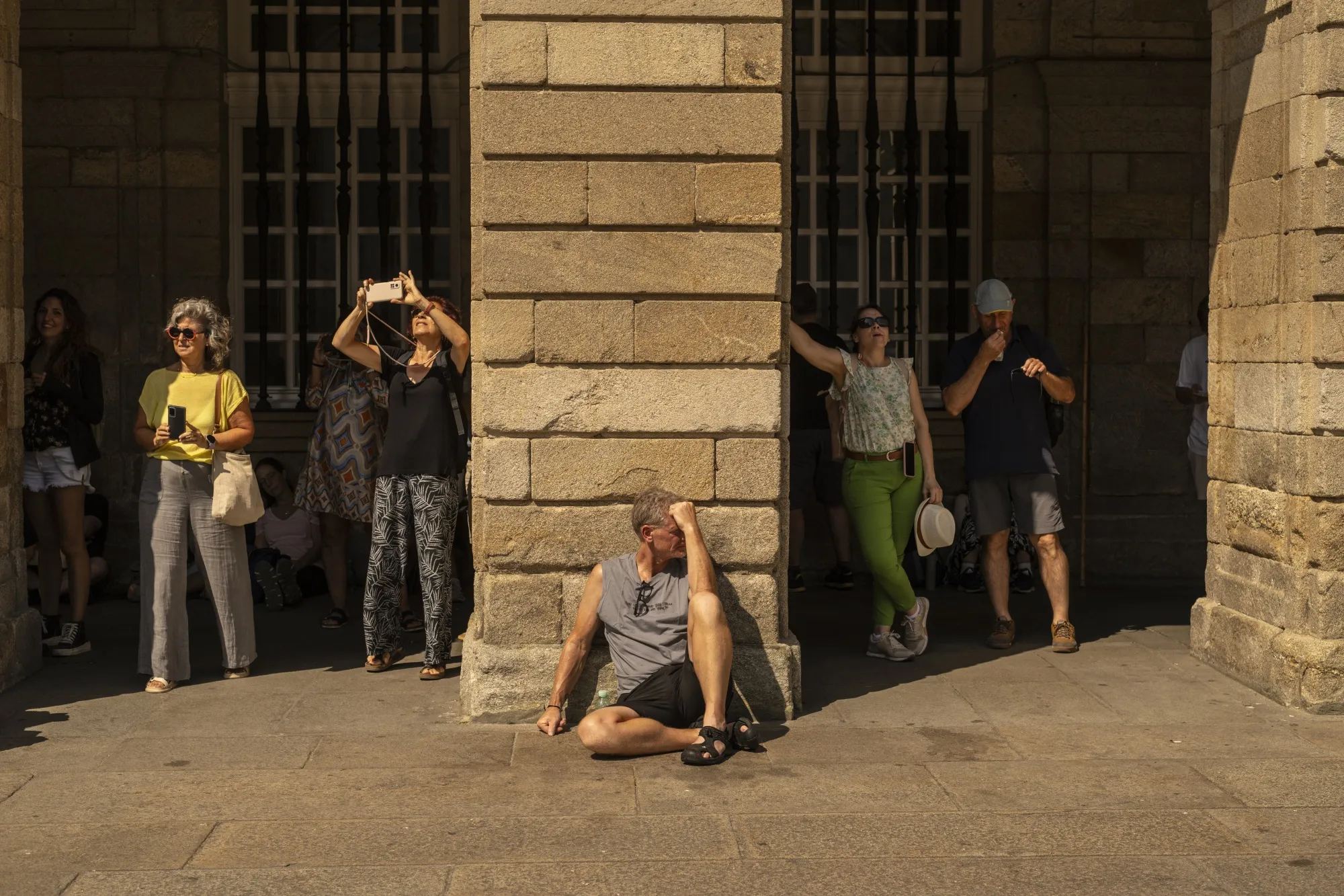 Tourists in the shade at Obradoiro Square during high temperatures in Santiago de Compostela, Spain, on Saturday, Aug, 10, 2024.&nbsp;