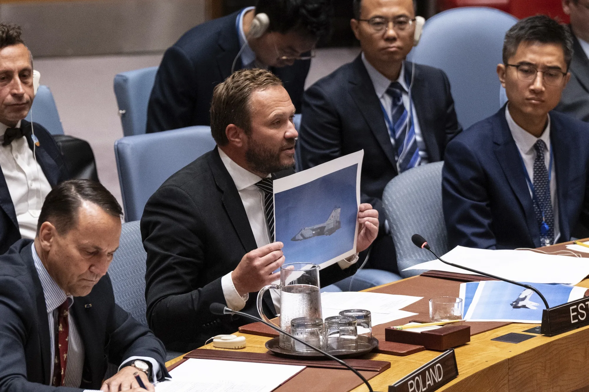 Minister for Foreign Affairs of Estonia Margus Tsahkna shows photos of Russian jets during a Security Council meeting at UN Headquarters in New York on Sept. 22.