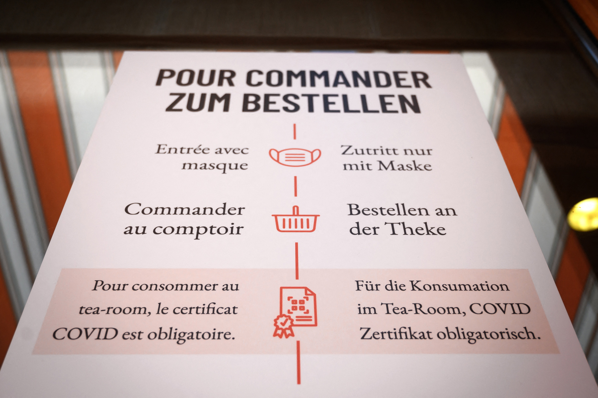 A poster requiring visitors to show a vaccine certificate at a tea room in Les Moulins, Switzerland, on Sept. 12.