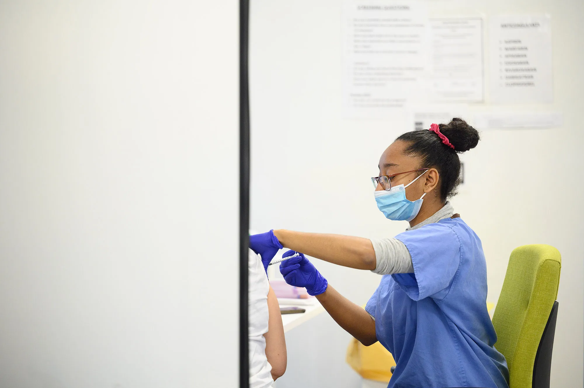 A woman receives her Covid-19 vaccination booster jab in London.