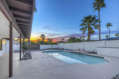 The pool may be prettier than this Phoenix home's barn doors, but the latter design feature is in higher demand.