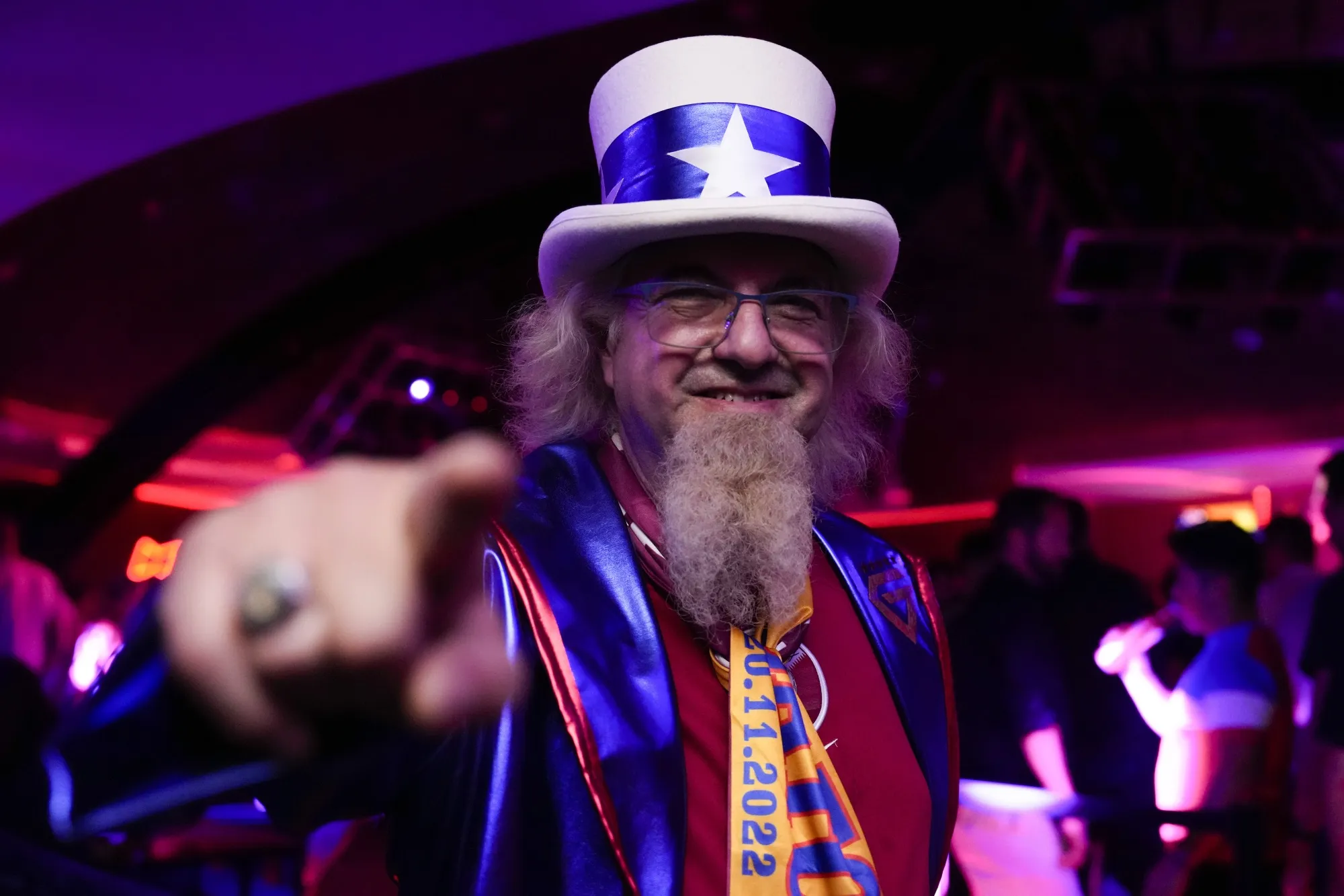 Hector Garcia, 59, of Glendale Heights, Illinois, poses for a photo during an official U.S. Soccer fan party at the FIFA World Club ahead of a group B soccer match between the United States and Wales, in Doha, Sunday, Nov. 20, 2022. He plans to attend 28 games during the 2022 FIFA World Cup. (AP Photo/Ashley Landis)