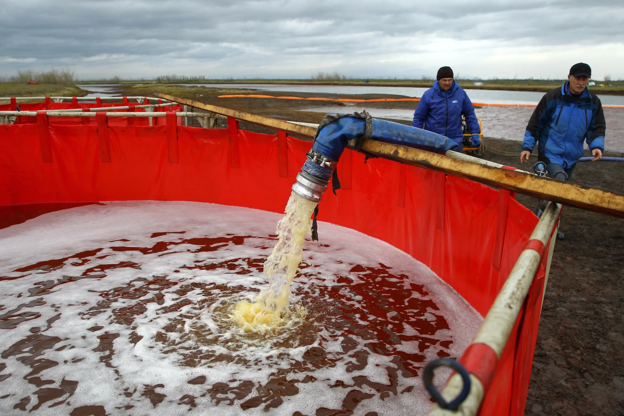 Workers take part in a clean-up operation following a fuel spill in the Ambarnaya River outside Norilsk on June 10.