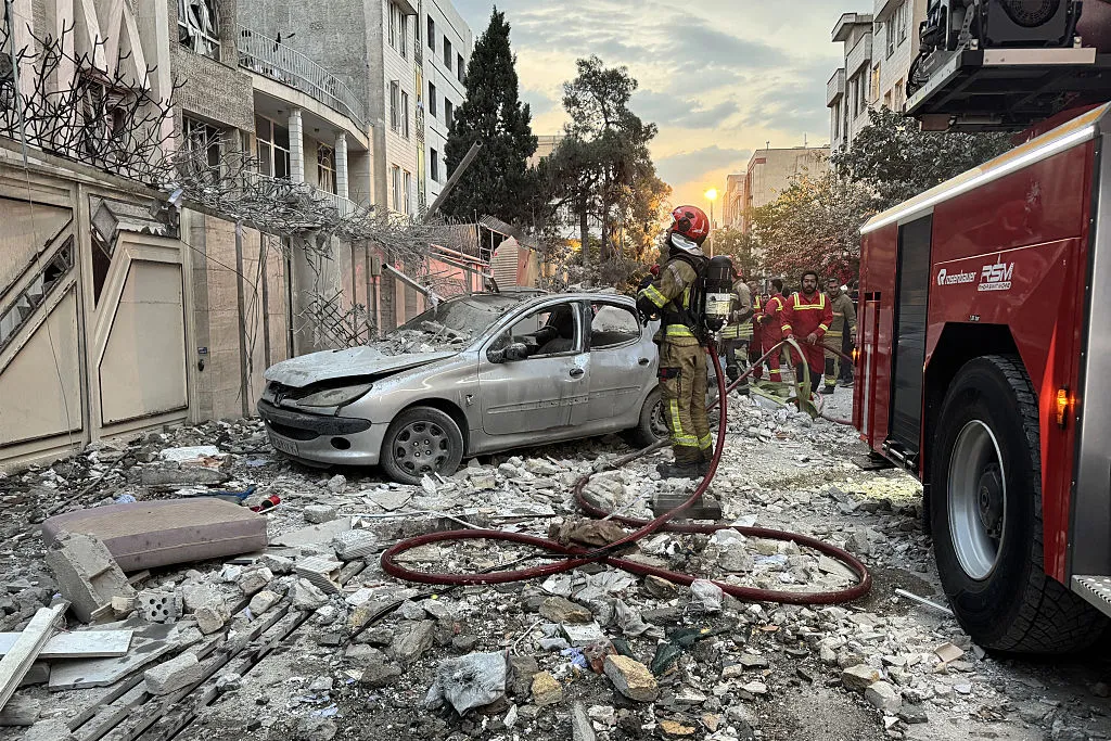 First-responders outside a building that was hit by an Israeli strike in Tehran on June 13.