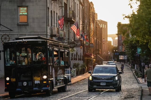 A tour trolley travels along River Street in Savannah.