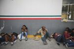 Asylum-seekers sit in Matamoros, Mexico, waiting to enter the U.S.
