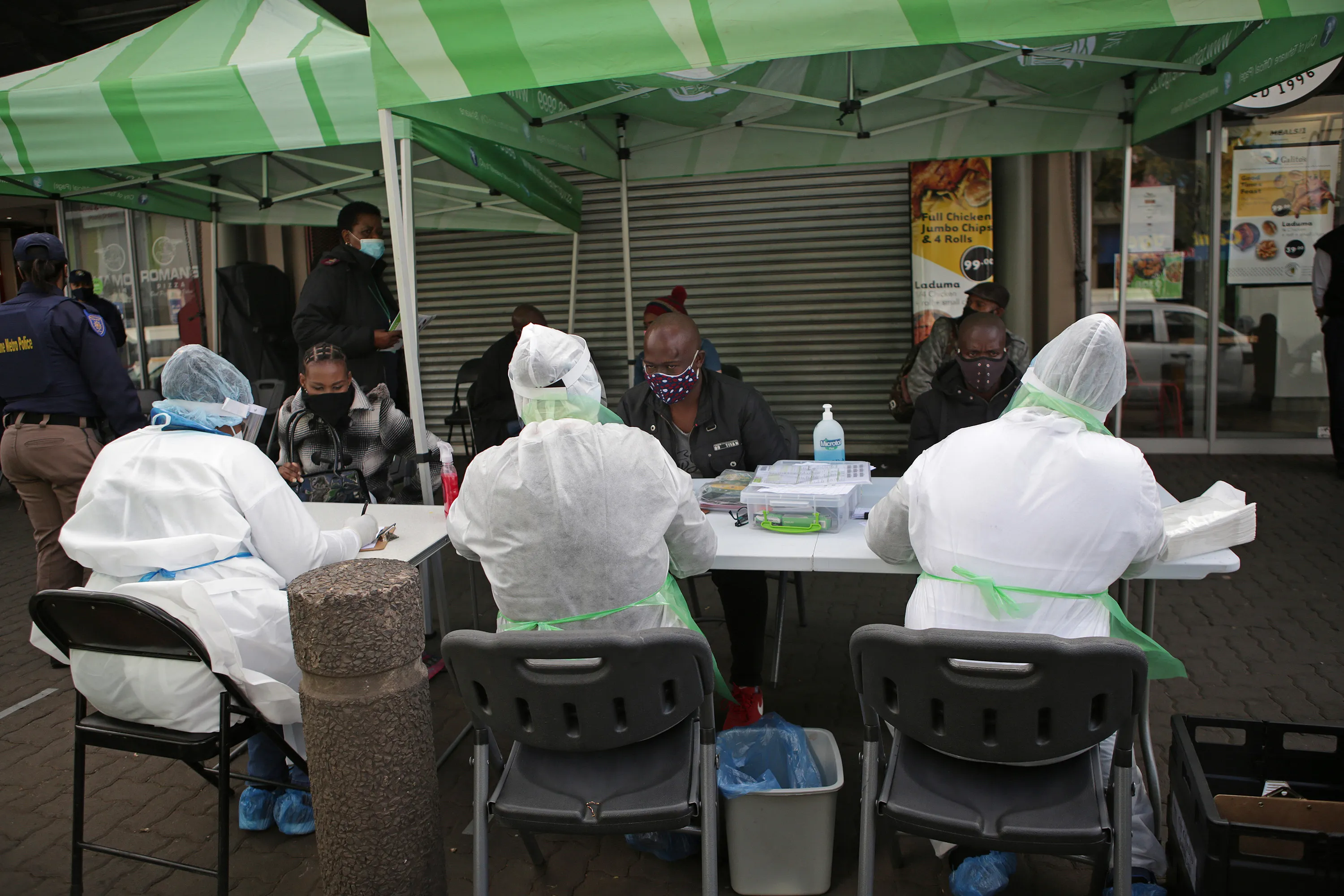 Officials conduct screen people prior to Covid-19 coronavirus testing in Pretoria, on&nbsp;June 11.