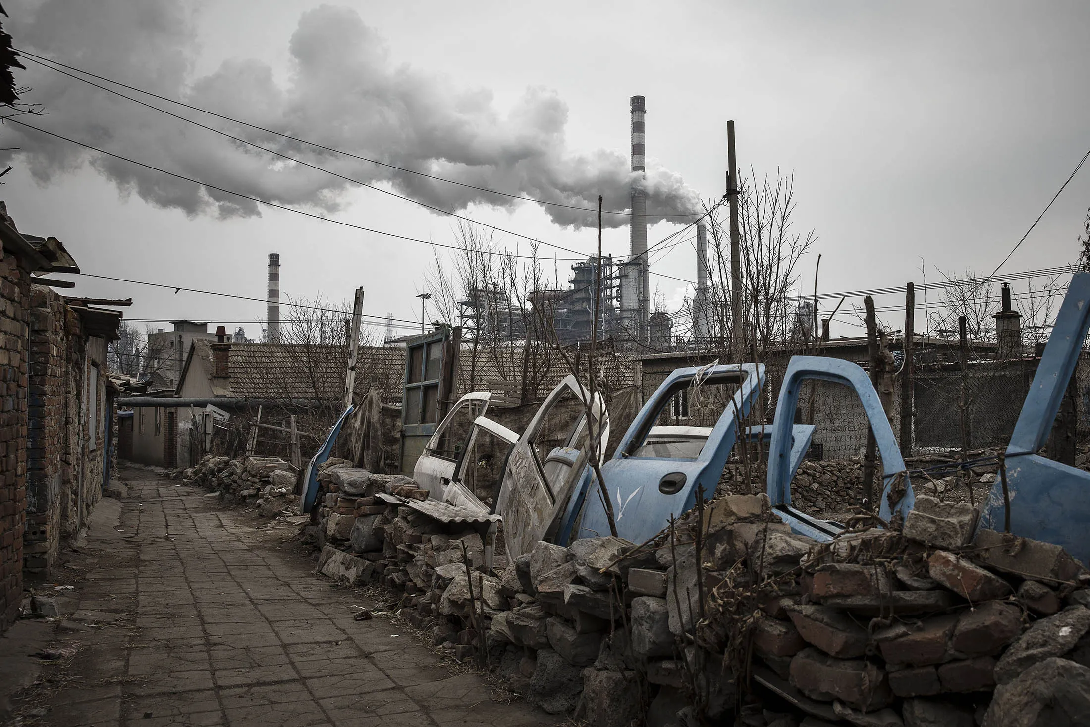 Smoke billows from a factory nearby in Dalian, China.
