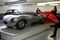 Employees remove a cloth covering a Jaguar XKSS on display at the Jaguar Classic workshop in Coventry, U.K.