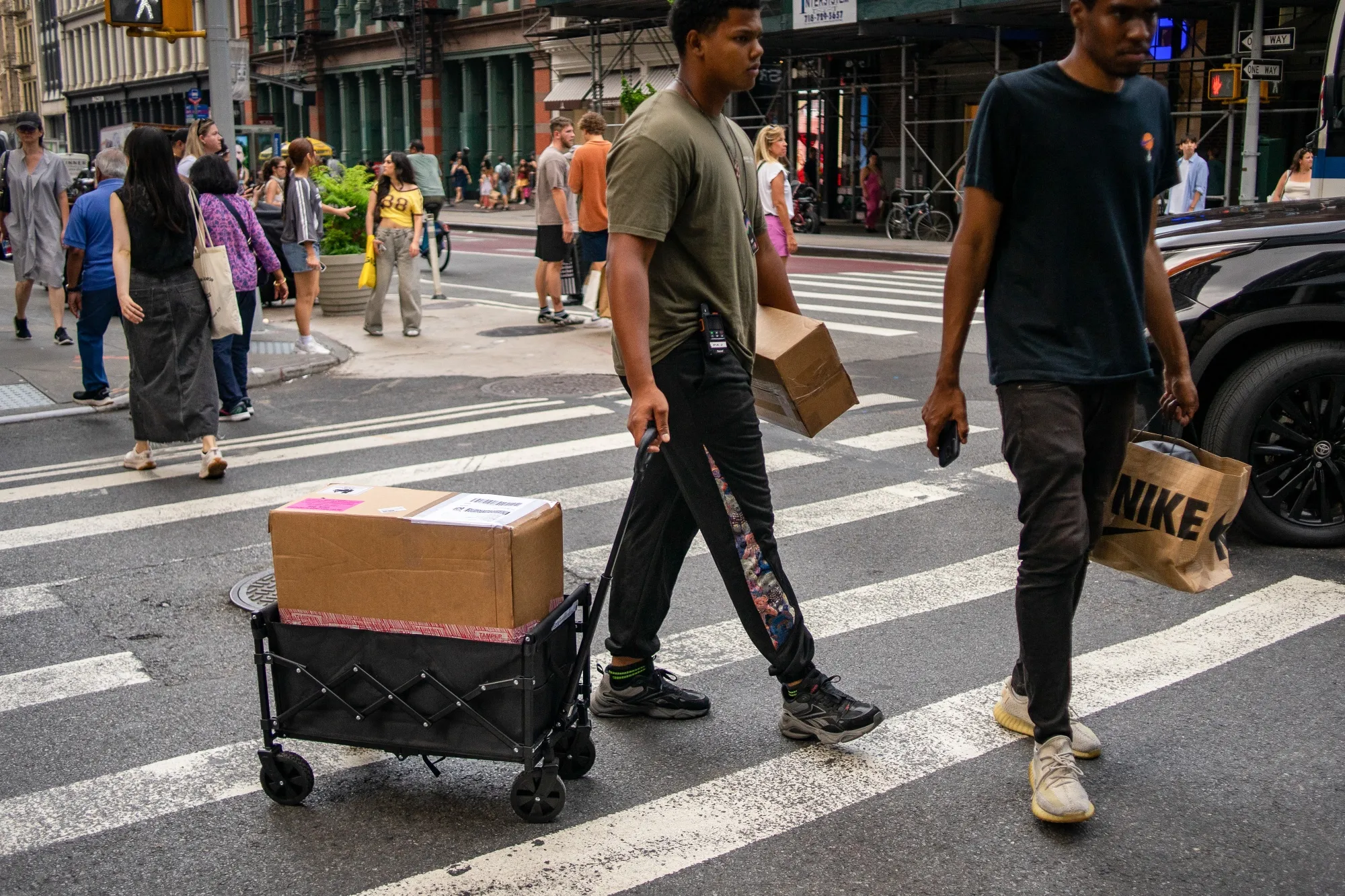 Shoppers and&nbsp;a delivery worker on Broadway in the Soho neighborhood of New York.