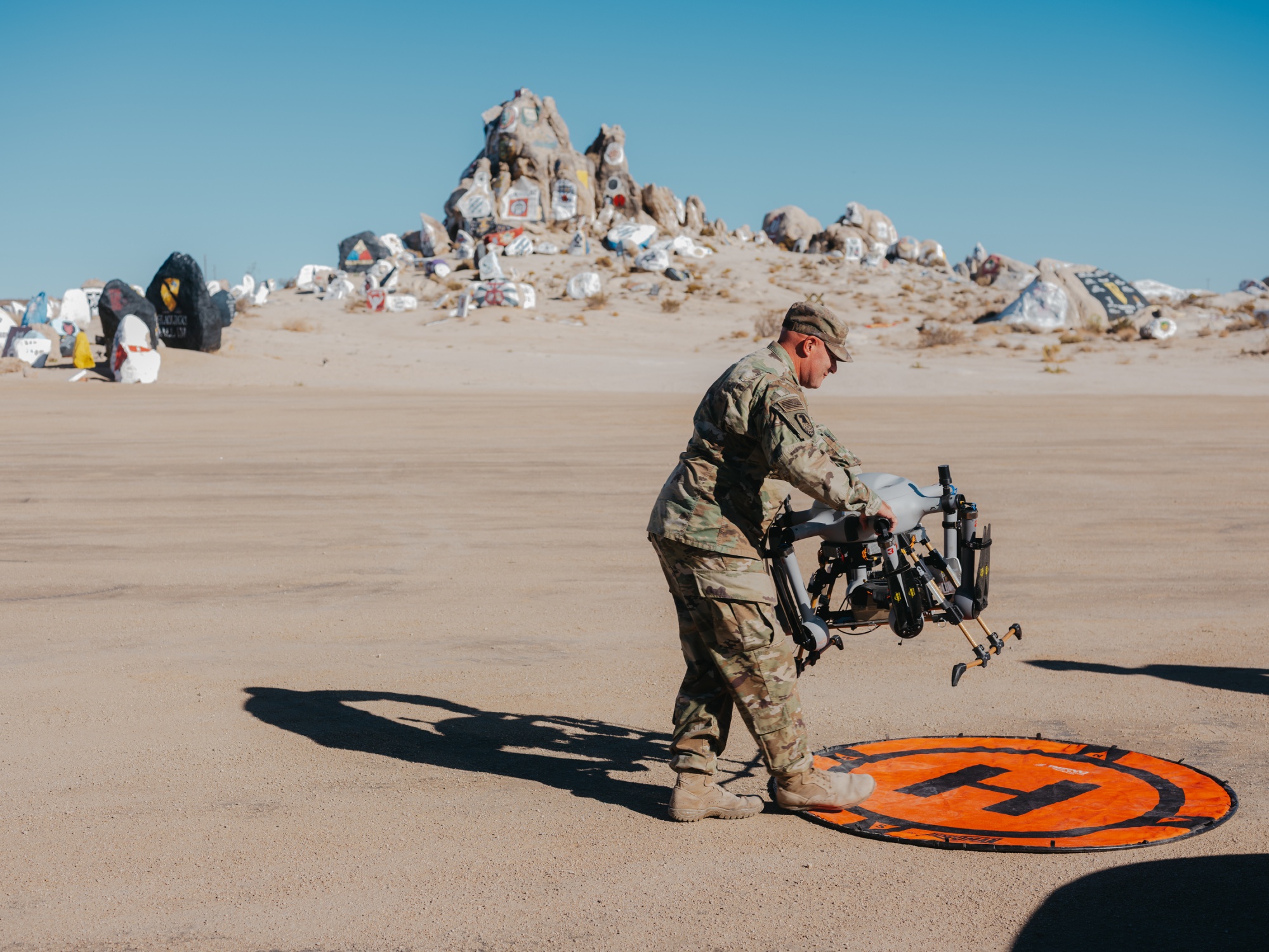 Chief Warrant Officer 2 Trenton Huntsinger brings out a group 2 drone for a presentation at the National Training Center (NTC) in Fort Irwin, California on Friday, November 7, 2025. Photo: Christopher Lee for Bloomberg Photographer: Christopher Lee