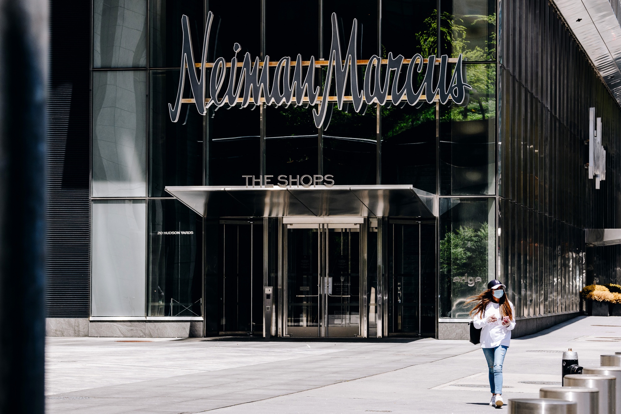 A pedestrian passes by a closed Neiman Marcus store in New York on May 5.