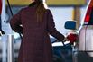 A driver refuels her vehicle
