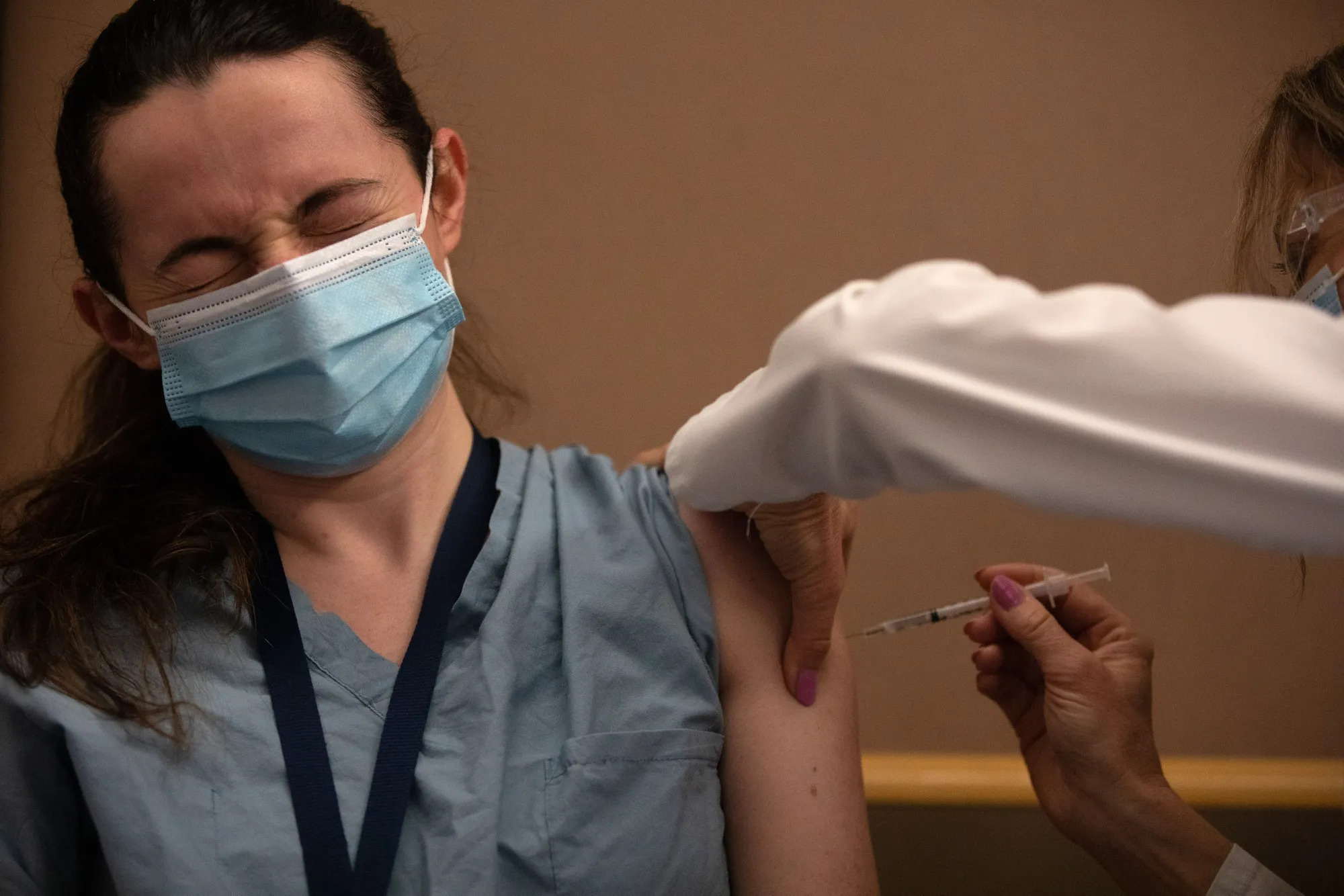 A health-care worker receives the Pfizer-BioNTech Covid-19 vaccine at the Michigan Medicine facility in Ann Arbor, Michigan, on Dec. 16.