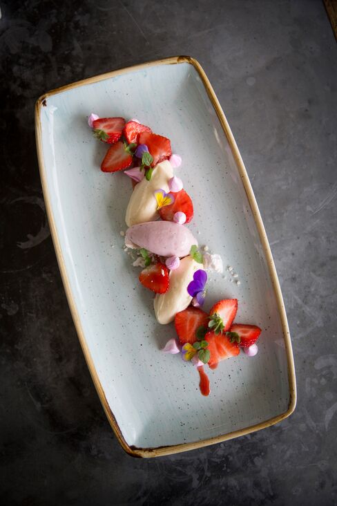 Strawberries and cream is artfully presented. It is perfect for a warm summer's day.