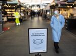 A sign requests visitors to wear masks at Torvehallerne food market in Copenhagen, Denmark.