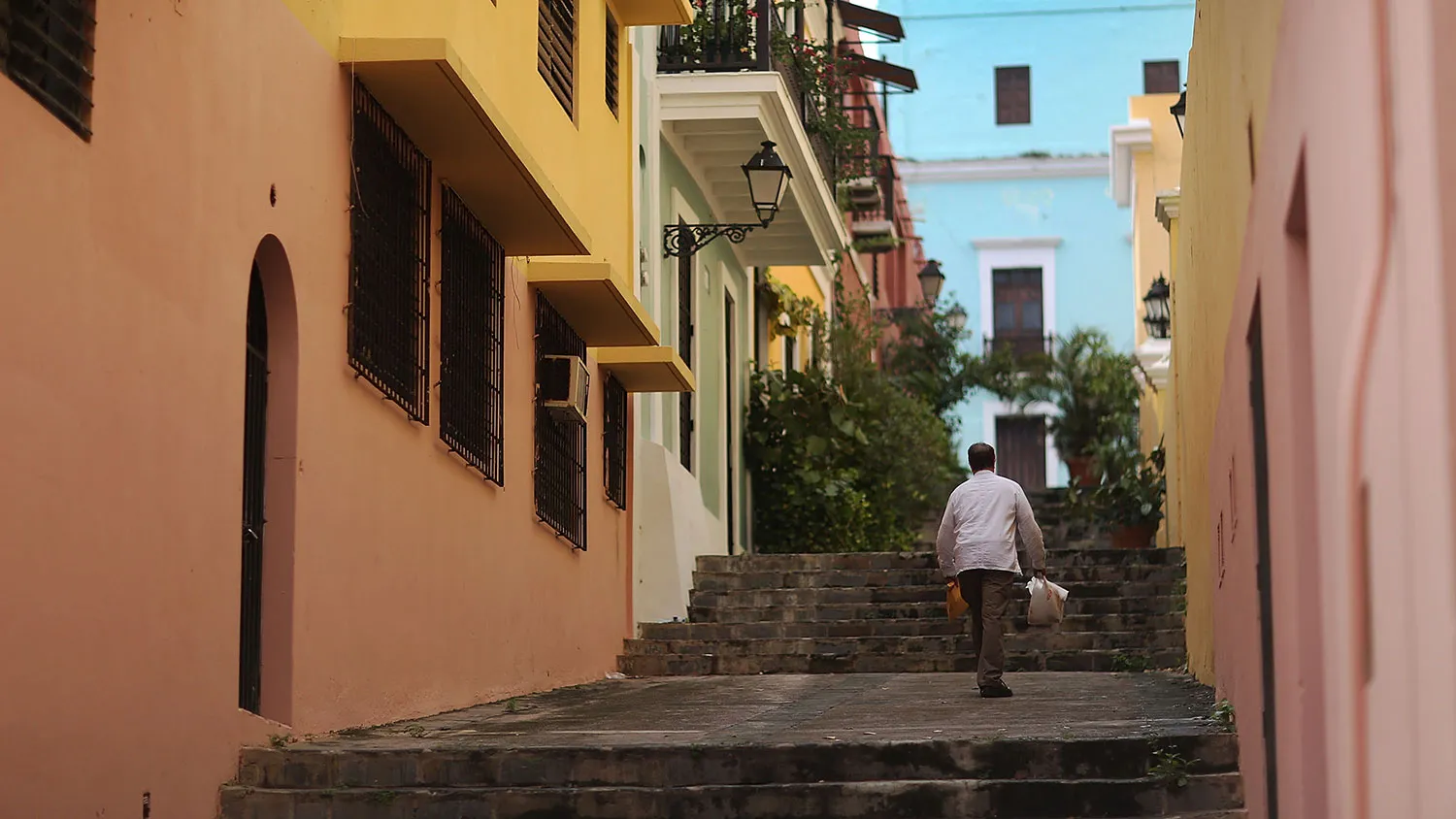 A pedestrian walks along a street in Old San Juan, Puerto Rico, on June 30, 2015.
