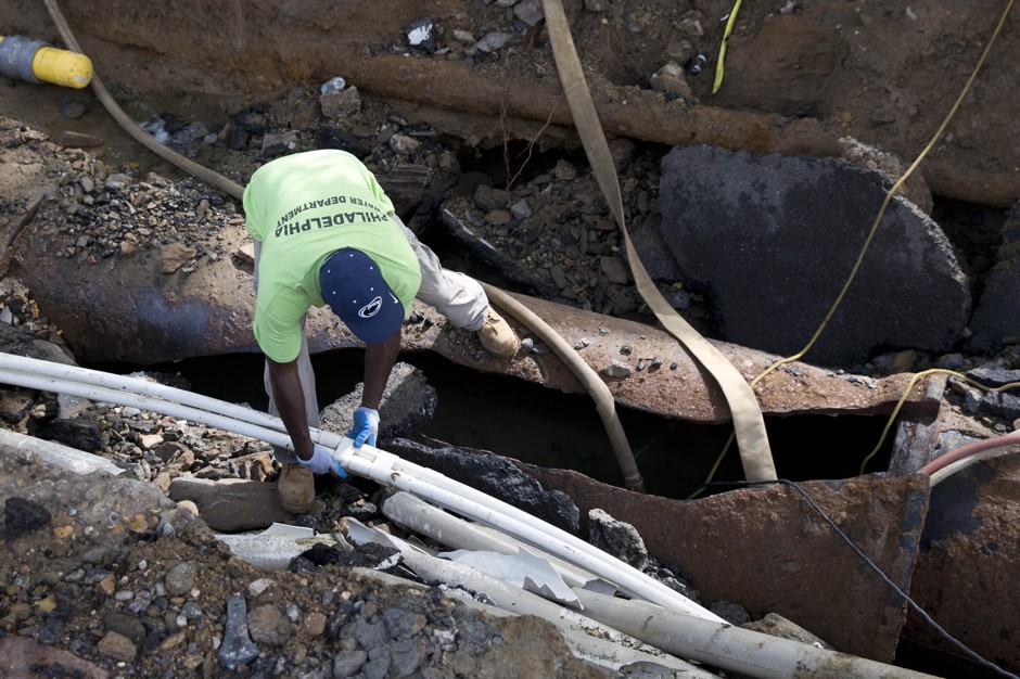 Repairs to a broken water main reveals the jumble of pipes and lines between city streets.