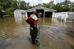 Kevin Grey looks at his flood damaged property in Sorrento, Louisiana.