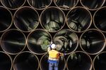 Nord Stream 2 pipeline segments stored at the port in Mukran, Germany are inspected by a worker (Photo by Ulrich Baumgarten via Getty Images)