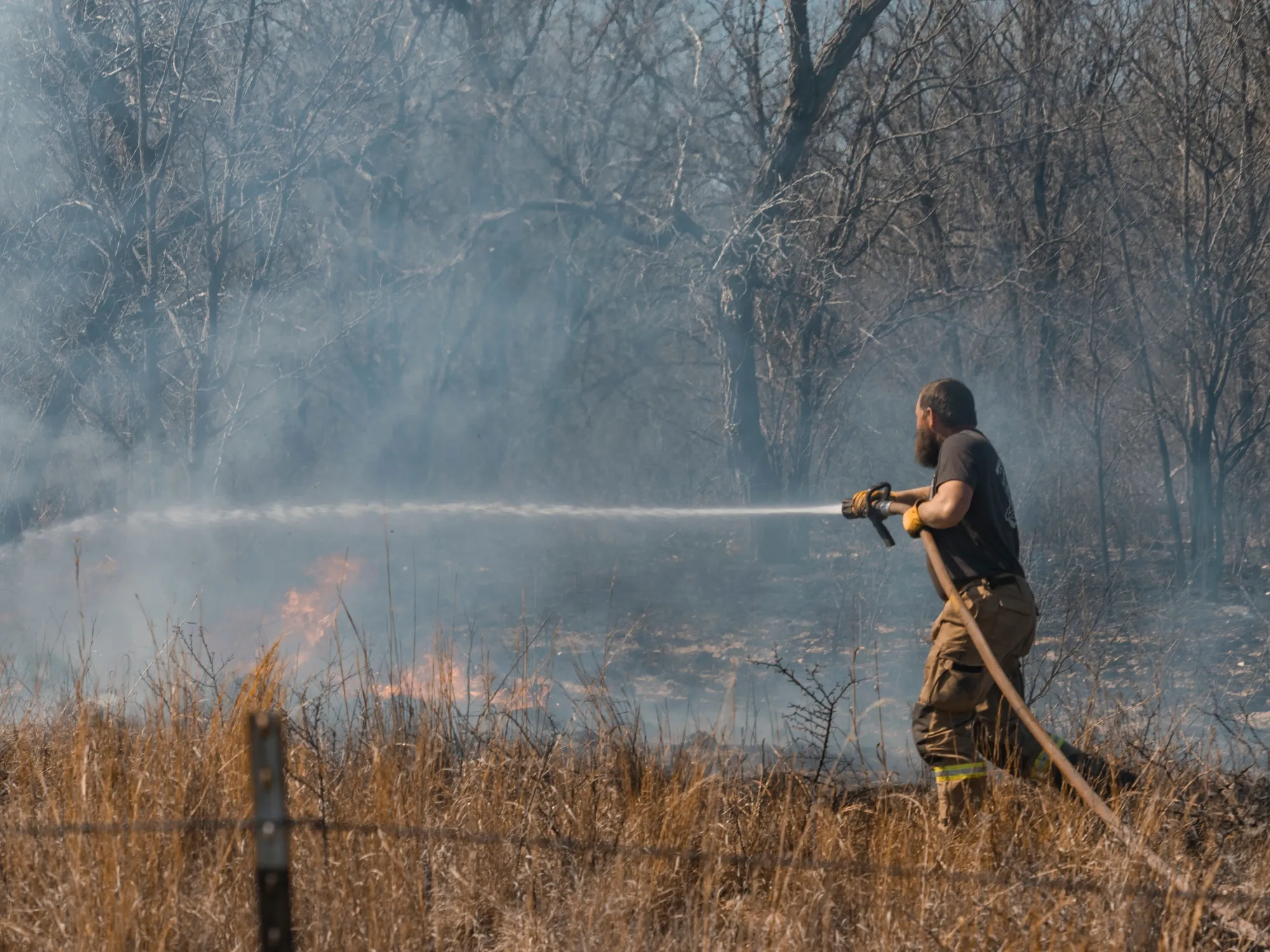 A firefighter extinguishes hotspots following the Smokehouse Creek Fire in Miami, Texas, on March 2.