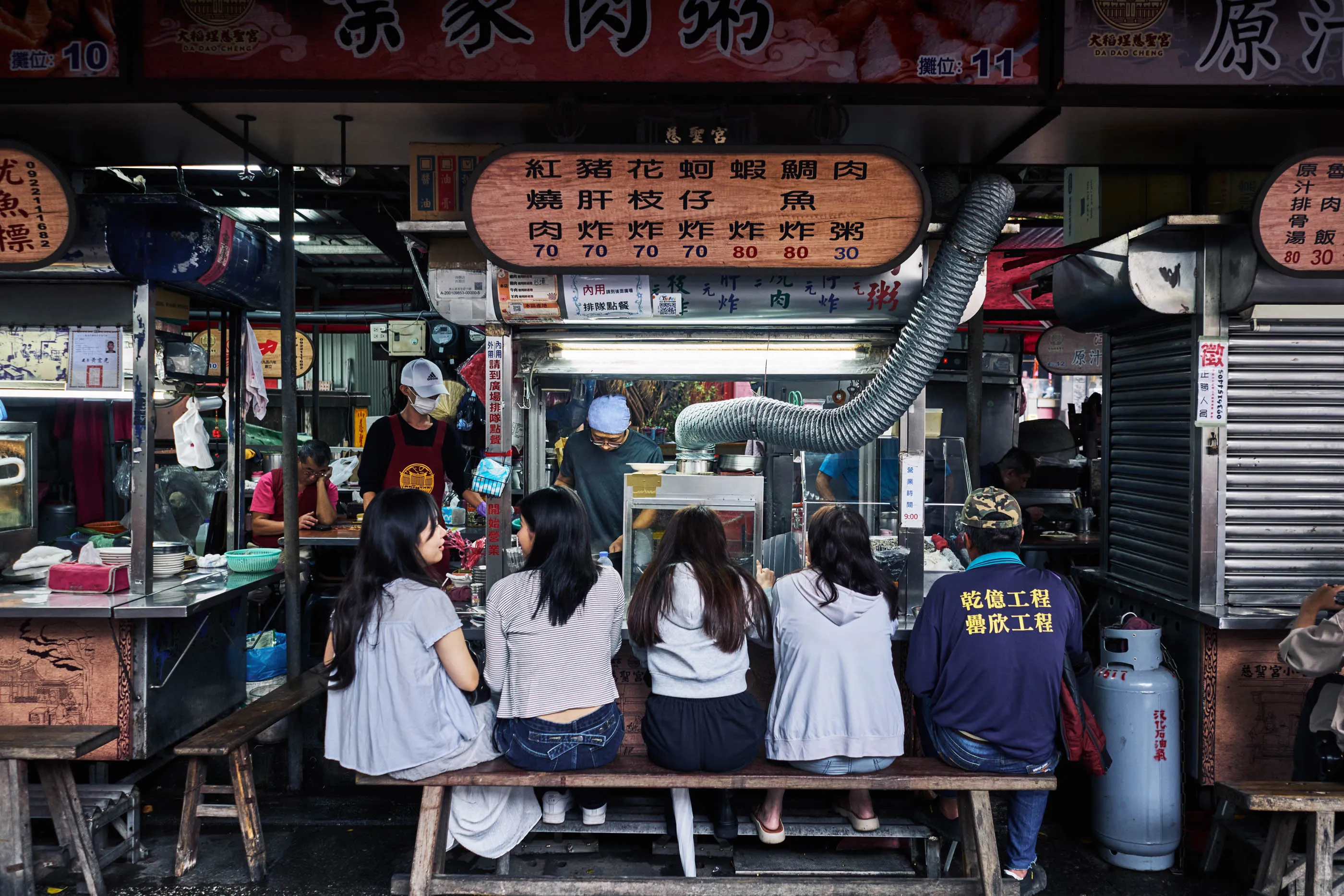 Diners at the Ye Jia Meat Porridge food stall near Dadaocheng Cisheng Temple, in Taipei.                                
