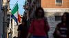 The national flag of Italy, front, flies along side the European Union (EU) flag in Rome.