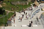 A jogger runs past people gathered during a partial lockdown imposed due to the coronavirus in Bondi Beach, Sydney on April 4.