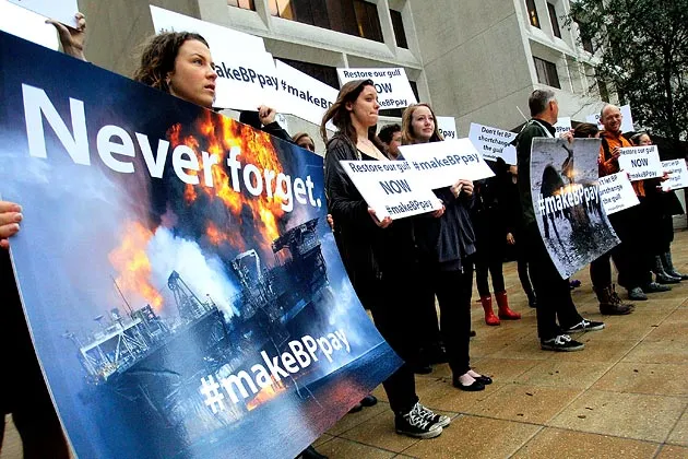 Activists  protest in front of the Federal Building on the first day of the trial over the Deep Water Horizon oil rig spill in New Orleans 