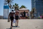 Visitors queue for entry at an access point to Nova Icaria beach in Barcelona, on June 28.