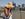 A pedestrian wearing a sunhat crosses the Millennium Bridge in London in 2023.