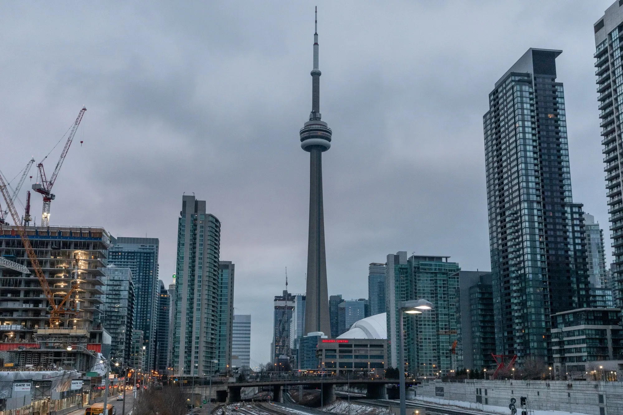 A residential building stands under construction in front of the CN tower in downtown Toronto, Ontario, Canada