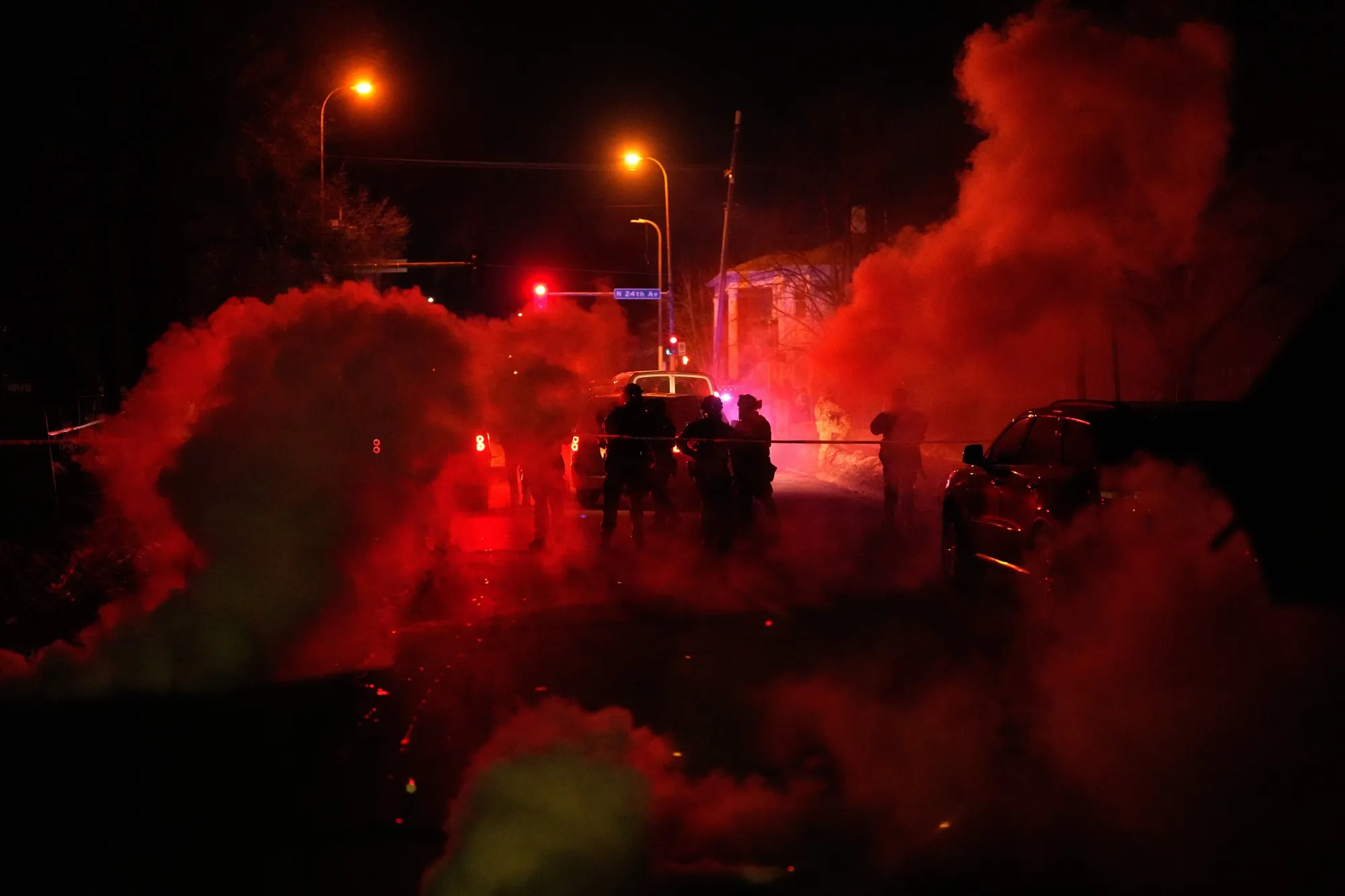Tear gas surrounds federal law enforcement officers as they leave the scene after the shooting.
