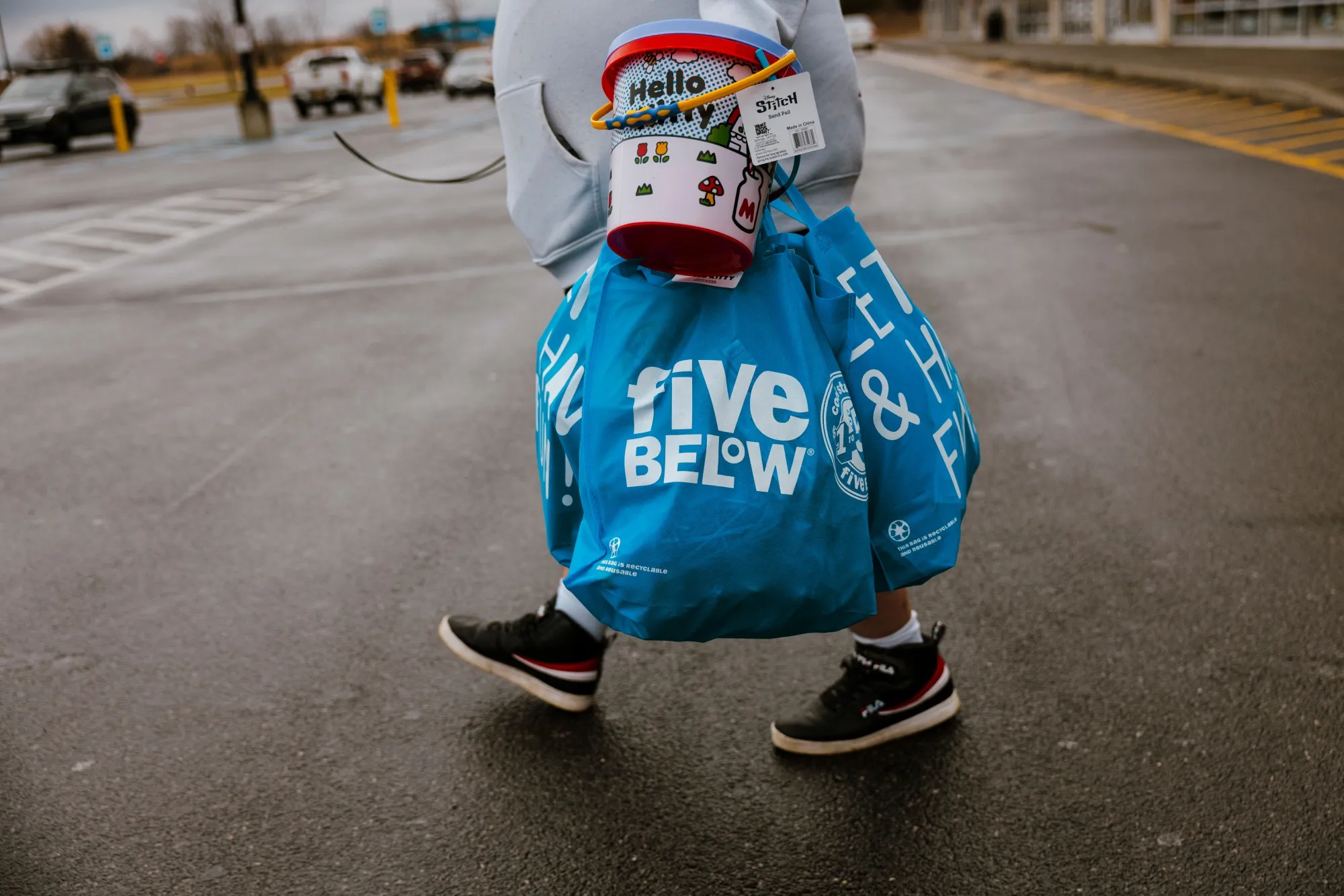A customer carries shopping bags outside a Five Below store in Hudson, New York.