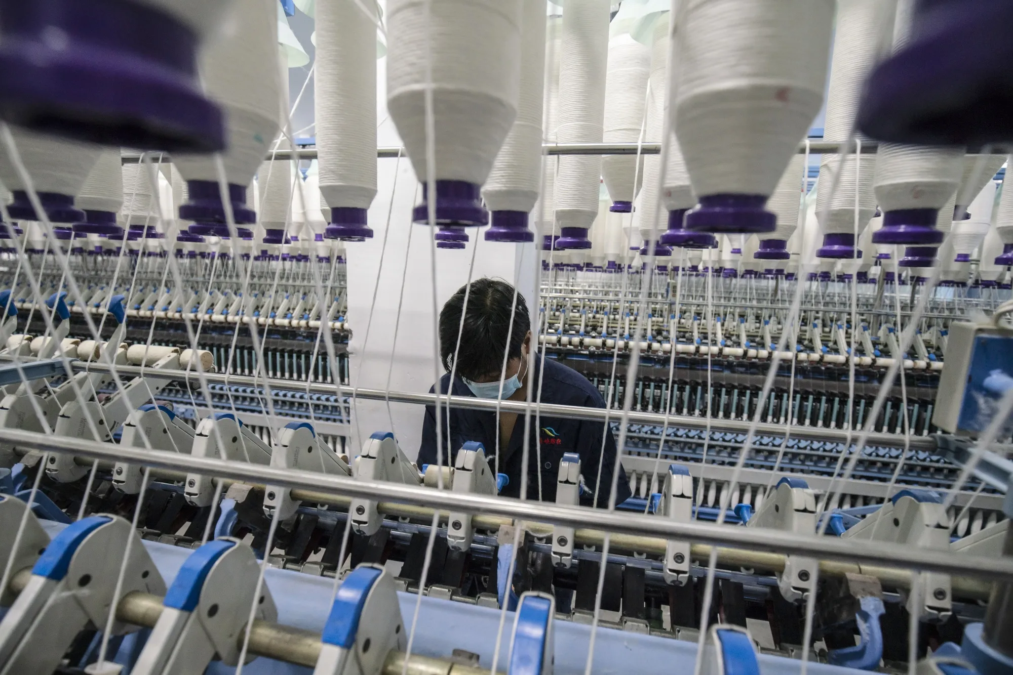 Inside a Textile Factory As China's Factories Roll on, Upending New Year’s Spending Patterns